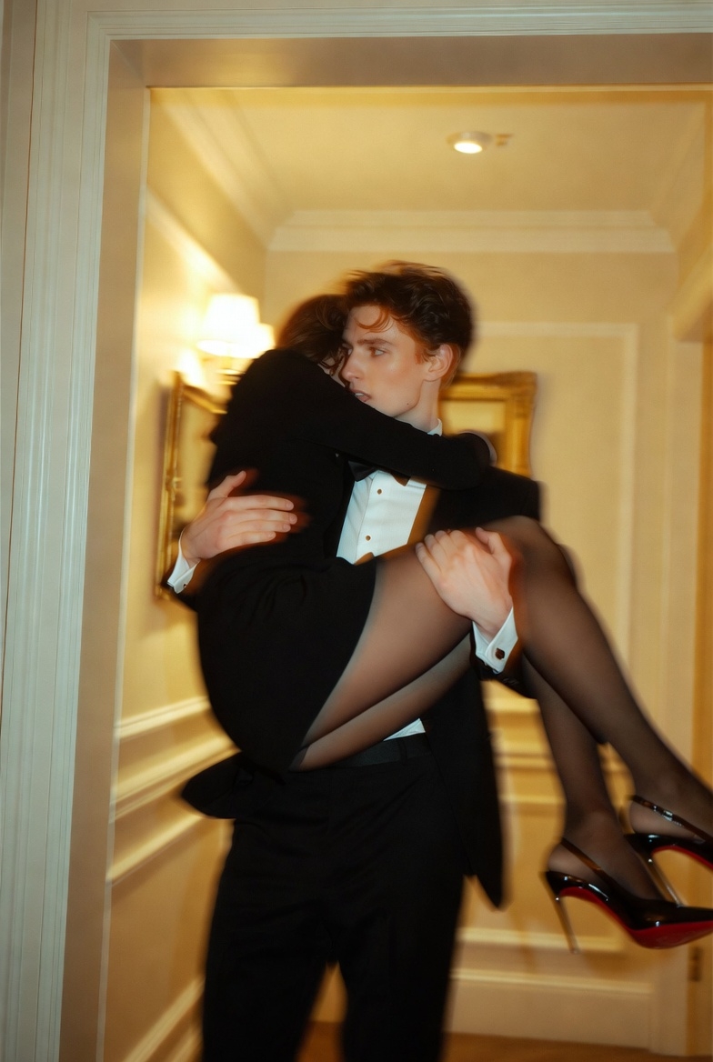 Tuxedoed Man Carrying a Woman through a Hallway